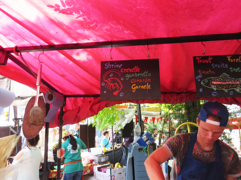 Fish sandwich stand at Camden Market with "shrimp" in many languages