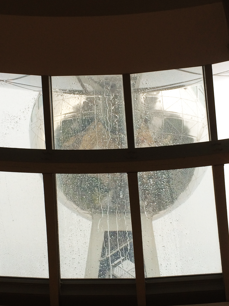 The Atomium, glimpsed from inside through a rain-covered window