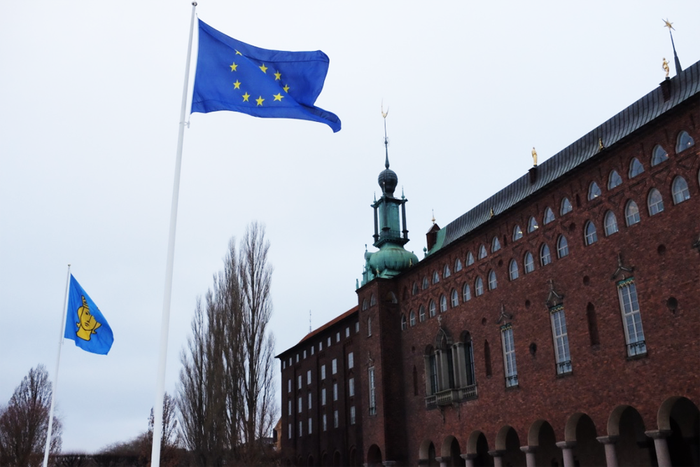 Stockholm's city hall's exterior from the street, with EU flag