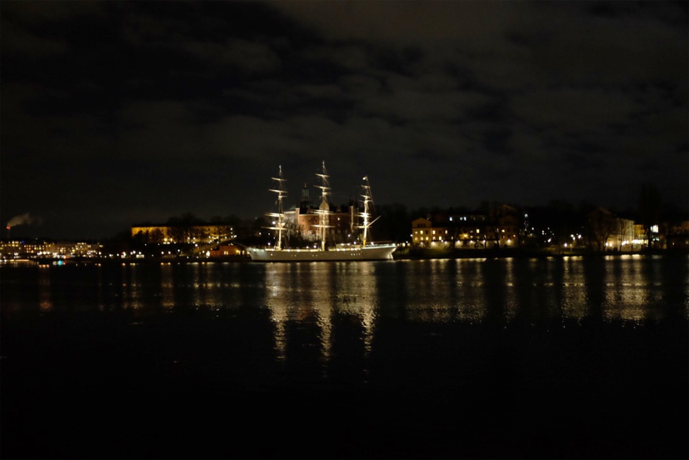 The Af Chapman at night, from across the harbor