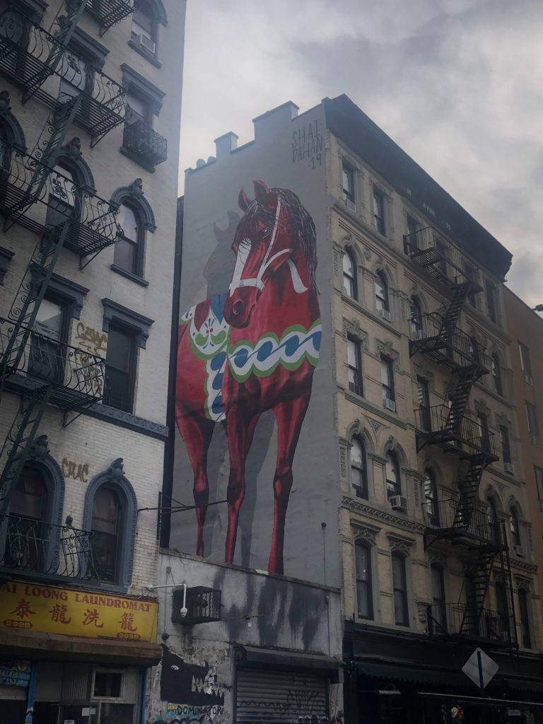 a painting of a Dala horse on a building in the Lower East Side of Manhattan