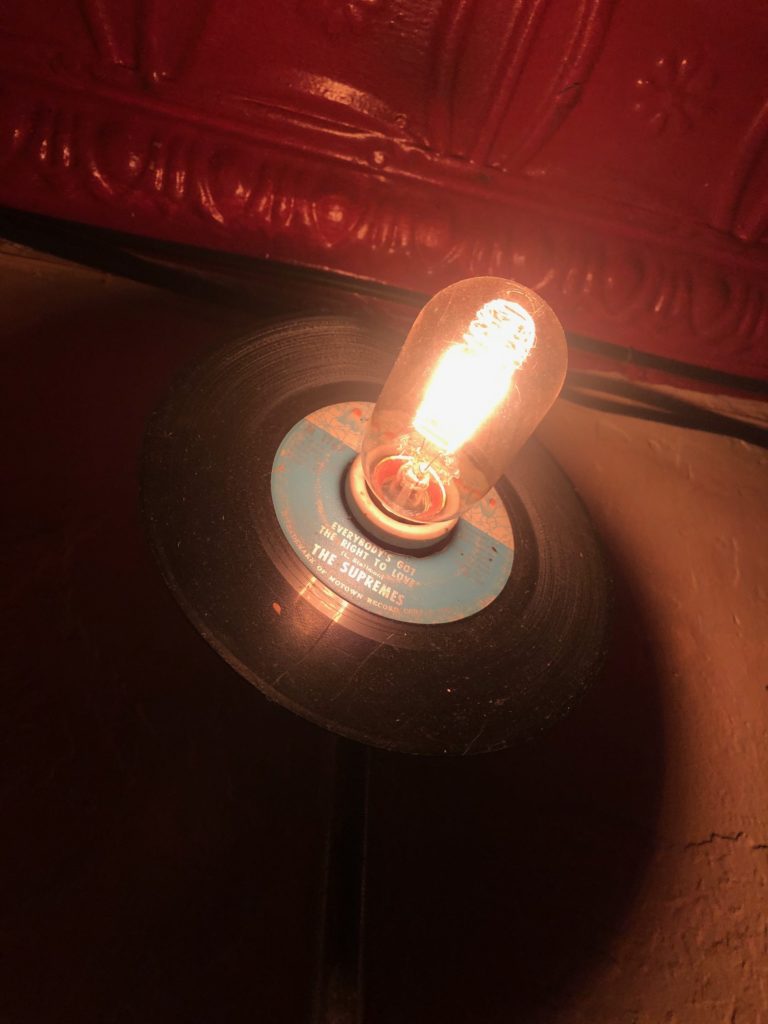 a lightbulb sticks out of a Supremes record