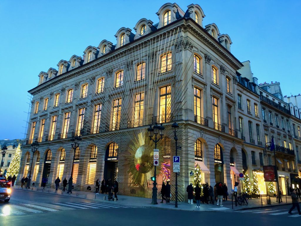 The Louis Vuitton store in Paris with a large sunburst decoration spanning one entire side of the building