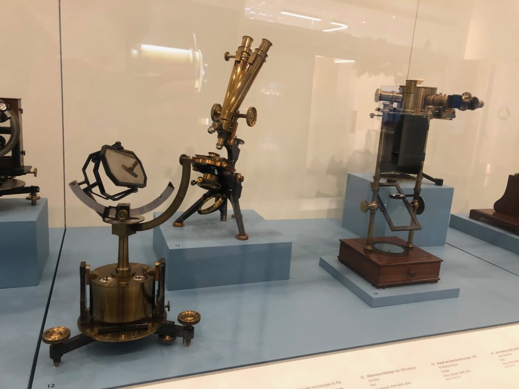 Brass scientific equipment behind glass